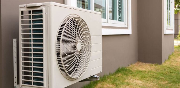 An outdoor unit installed in the back of a house. It appears clean and well maintained, on par with the Complete AC Tune-Up Checklist for Homeowners.