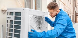 A man installing the split type aircon.
