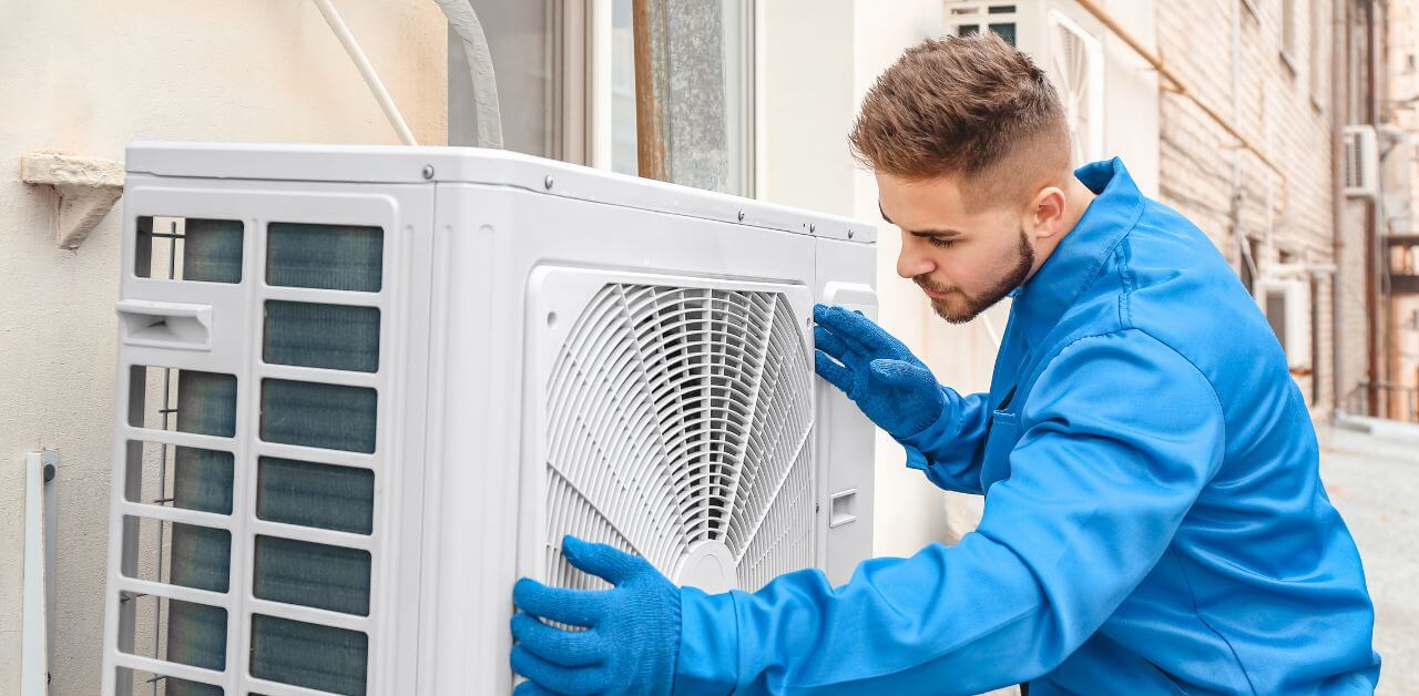 A man installing the split type aircon.