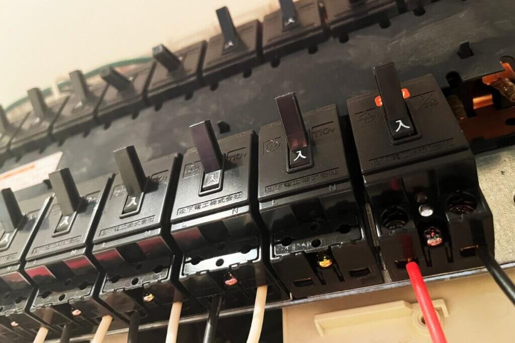 A series of Residual Current Devices installed in a row in a wall.