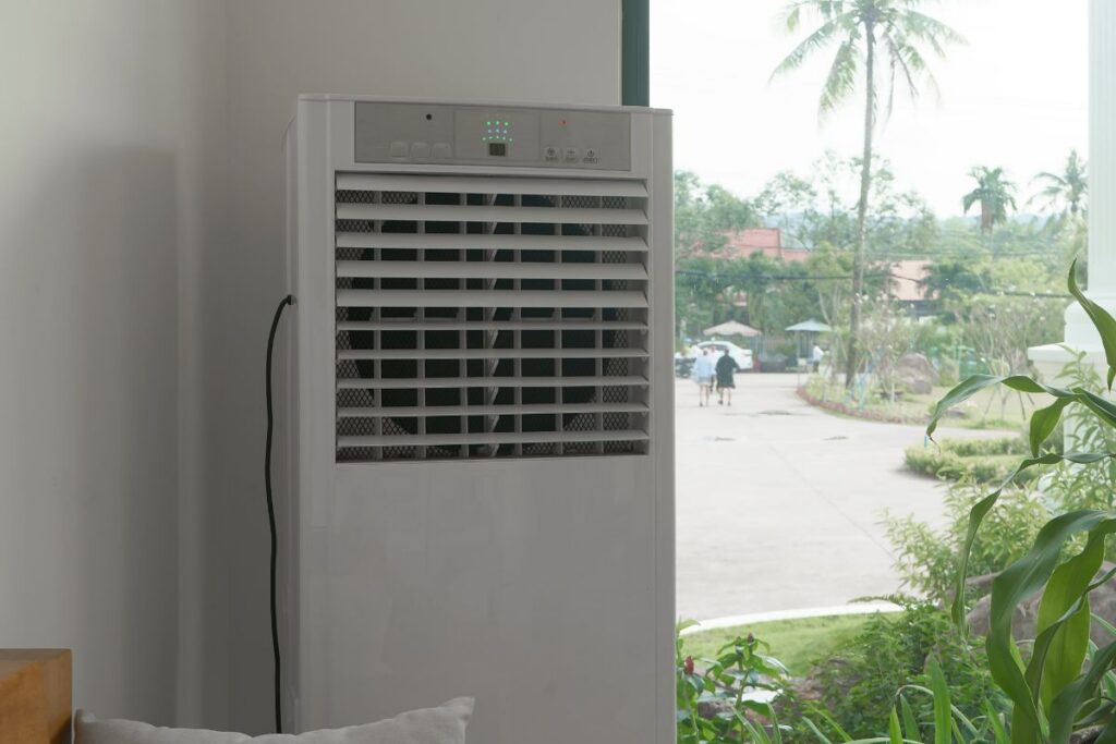 An evaporative cooler in an indoor setting. This article talks about Evaporative Cooler Installation: How Long It Takes, What It Costs + What Affects Performance.